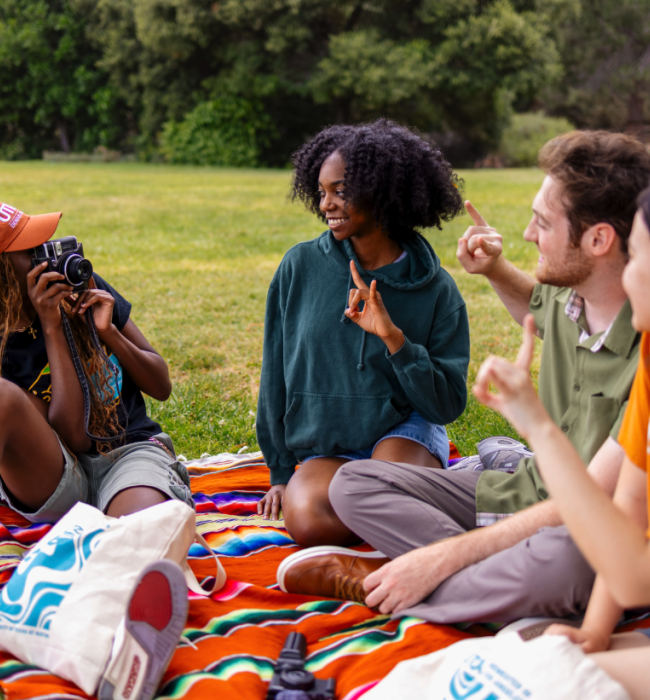 Students having a picnic in a field
