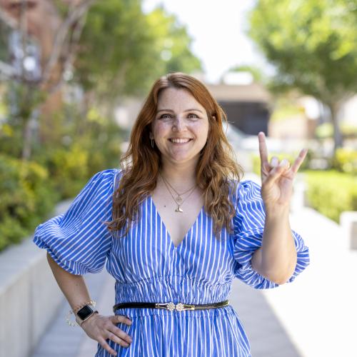 Colleen Morgan doing Hook 'Em Horns hand sign